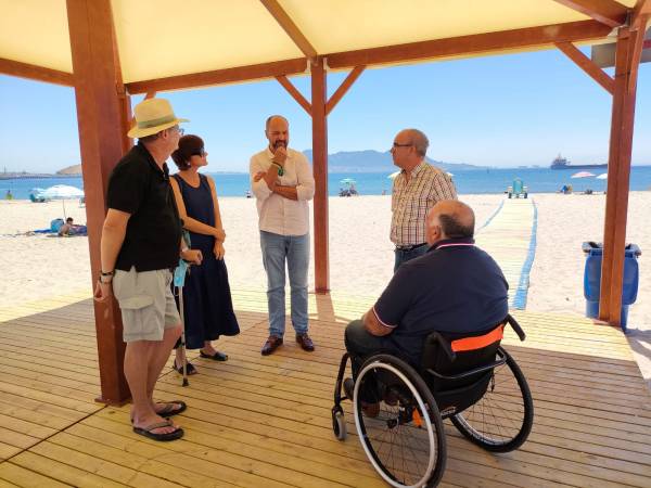 Alconchel y Gómez visitan la zona de sombra adaptada para personas con movilidad reducida en la playa de Palmones